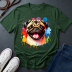 Green t-shirt with a colorful pug design on a dark surface with shoes and jeans.