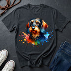Black t-shirt with a colorful dog graphic on a dark surface with shoes and jeans.