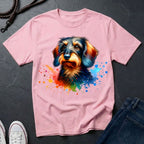 Pink t-shirt with a colorful dog graphic on a dark surface with jeans and shoes.