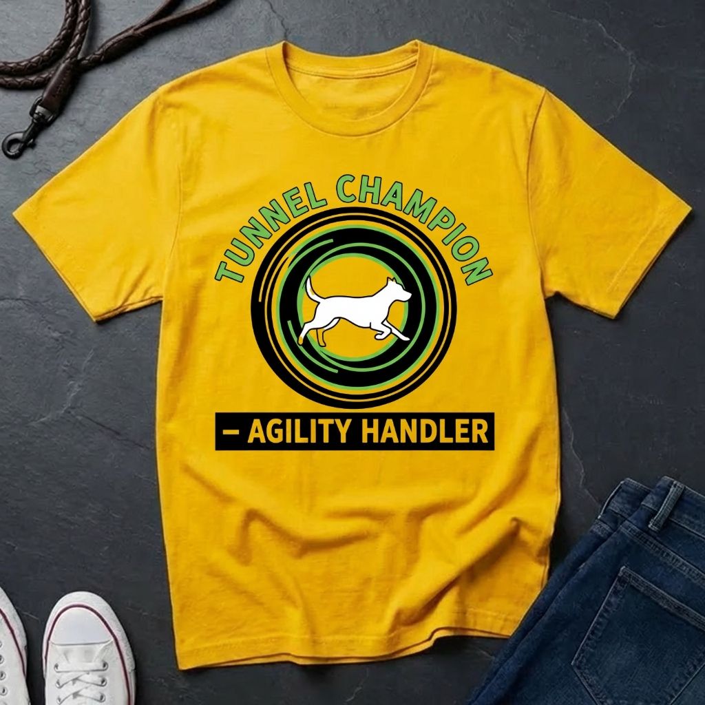 Beige t-shirt with 'Tunnel Champion Agility Handler' graphic on a dark surface with shoes and jeans.