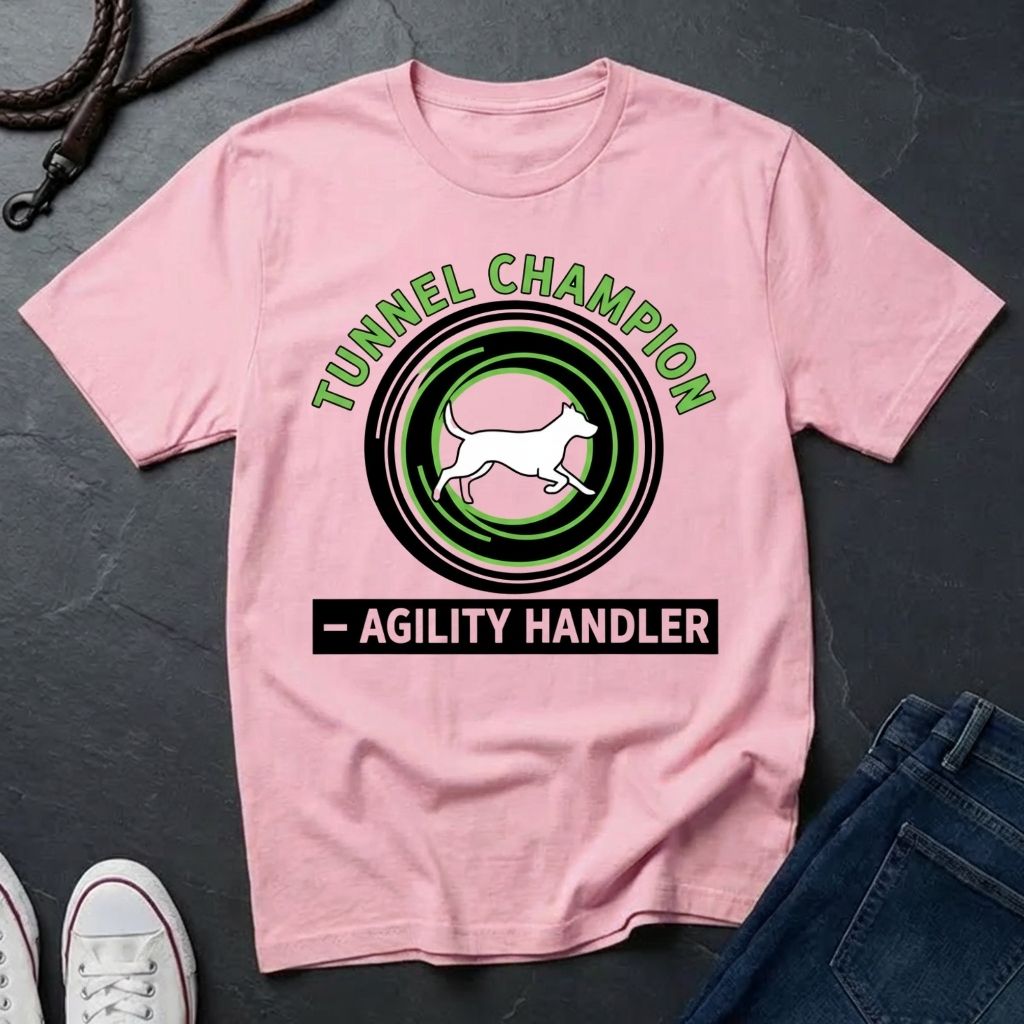 Beige t-shirt with 'Tunnel Champion Agility Handler' graphic on a dark surface with shoes and jeans.
