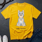 Yellow Comfort Colors t-shirt with a Silky Terrier graphic and text on a dark surface.