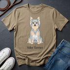 Beige Comfort Colors t-shirt with Silky Terrier graphic and text on a dark surface with shoes and jeans.