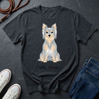 Black Comfort Colors t-shirt with Silky Terrier graphic and text on a dark surface with shoes and jeans.