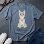 Blue Comfort Colors t-shirt with Silky Terrier graphic and text on a dark surface with shoes and jeans.