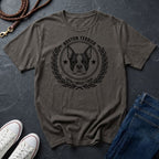 Gray Comfort Colors t-shirt with Boston Terrier graphic and text on a dark surface with shoes and jeans.