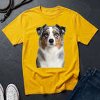 Yellow Comfort Colors t-shirt with a dog graphic on a dark surface with shoes and jeans.