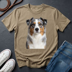 Beige Comfort Colors t-shirt with a dog graphic on a dark surface with shoes and jeans.