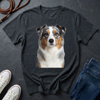 Black Comfort Colors t-shirt with a dog graphic on a dark surface with shoes and jeans.