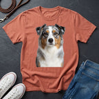 Brown Comfort Colors t-shirt with a dog graphic on a dark surface with shoes and jeans.