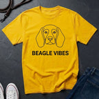 Yellow Comfort Colors t-shirt with a beagle graphic and 'Beagle Vibes' text on a dark surface.