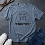Blue Comfort Colors t-shirt with beagle graphic and 'Beagle Vibes' text on a dark surface with shoes and jeans.