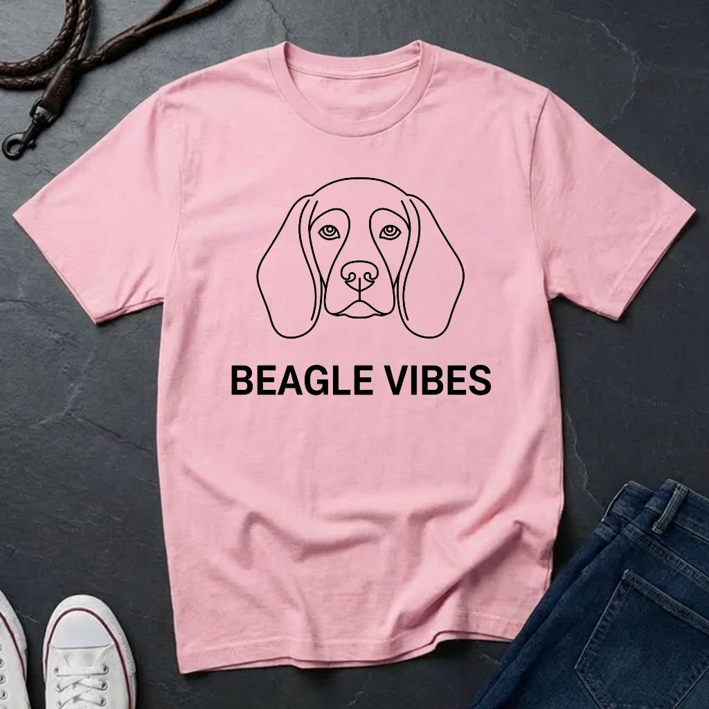 Pink Comfort Colors t-shirt with beagle graphic and 'Beagle Vibes' text on a dark surface.