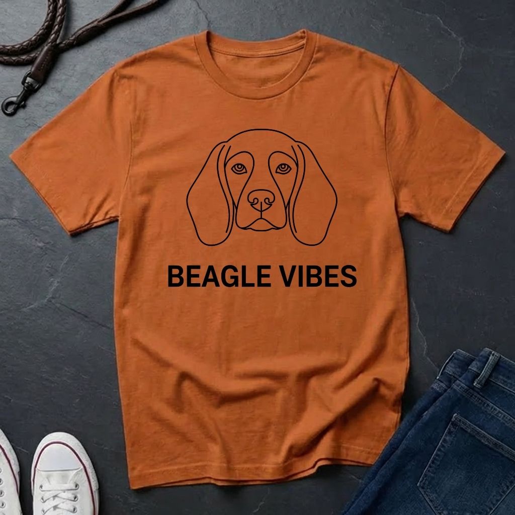 Orange Comfort Colors t-shirt with beagle graphic and 'Beagle Vibes' text on a dark surface.