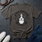 Gray Comfort Colors t-shirt with Bernese Mountain Dog graphic and text on a dark surface with shoes and jeans.