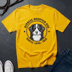 Yellow Comfort Colors t-shirt with Bernese Mountain Dog graphic and text on a dark surface.