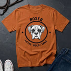 Orange Comfort Colors t-shirt with boxer dog graphic and text on a dark surface