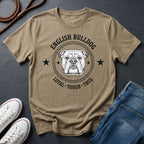 Beige Comfort Colors t-shirt with English Bulldog graphic and text on a dark surface with shoes and jeans.