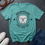 Teal Comfort Colors t-shirt with English Bulldog graphic and text on a dark surface with shoes and jeans.