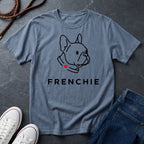 Blue Comfort Colors t-shirt with a dog graphic and 'FRENCHIE' text on a dark surface with shoes and jeans.