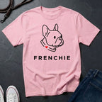 Pink Comfort Colors t-shirt with a dog illustration and 'FRENCHIE' text on a dark surface.