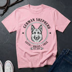 Pink Comfort Colors t-shirt with German Shepherd graphic and text on a dark surface