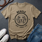 Beige Comfort Colors t-shirt with beagle graphic and text on a dark surface with shoes and jeans.