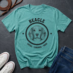 Teal Comfort Colors t-shirt with beagle graphic and text on a dark surface with shoes and jeans.
