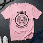 Pink Comfort Colors t-shirt with beagle graphic and text on a dark surface
