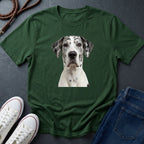 Green Comfort Colors t-shirt with a dog graphic on a dark surface with shoes and jeans.
