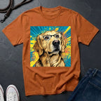 Brown Comfort Colors t-shirt with a dog wearing glasses graphic on a dark surface