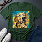 Green Comfort Colors t-shirt with a dog wearing glasses graphic on a dark surface with shoes and jeans.