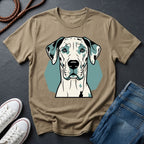 Beige Comfort Colors t-shirt with a dog graphic on a dark surface with shoes and jeans.