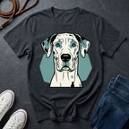 Black Comfort Colors t-shirt with a dog graphic on a dark surface with shoes and jeans.