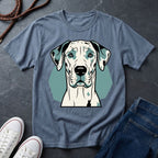 Blue Comfort Colors t-shirt with a dog graphic on a dark surface with shoes and jeans.
