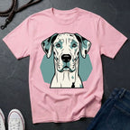 Pink Comfort Colors t-shirt with a dog graphic on a dark surface with jeans and shoes.