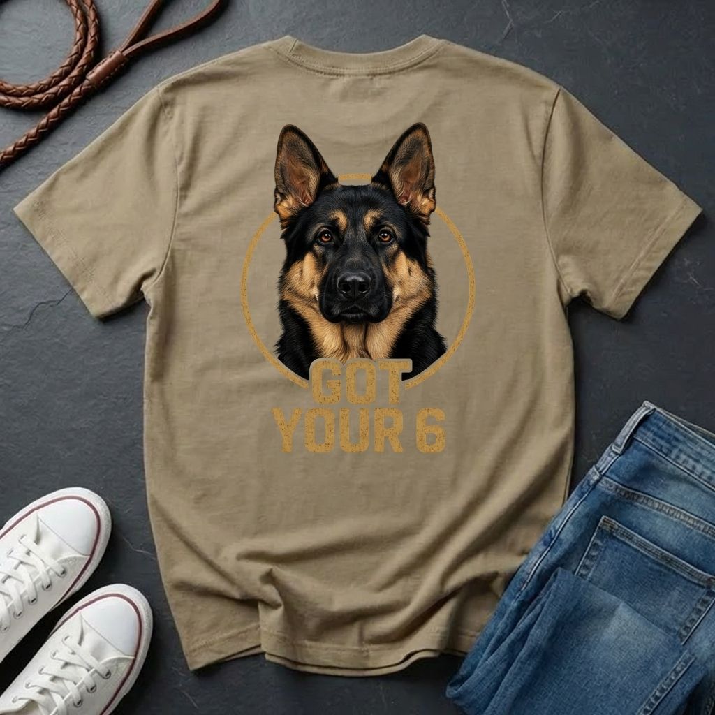 Beige Comfort Colors t-shirt with a German Shepherd graphic and 'Got Your 6' text, displayed with jeans and sneakers on a dark surface.