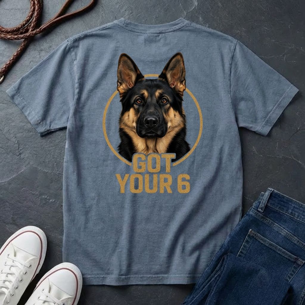 Blue Comfort Colors t-shirt with a German Shepherd graphic and 'Got Your 6' text on a dark surface with shoes and jeans.