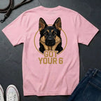 Pink Comfort Colors t-shirt with a dog graphic and 'Got Your 6' text on a dark surface.