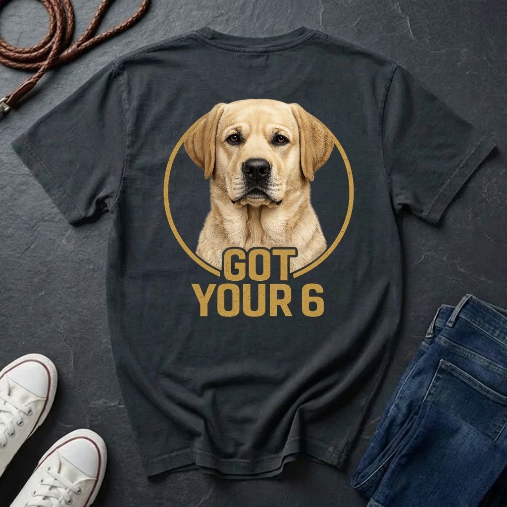 Black Comfort Colors t-shirt with a dog graphic and 'Got Your 6' text on a dark surface with shoes and jeans.
