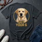 Black Comfort Colors t-shirt with a dog graphic and 'Got Your 6' text on a dark surface with shoes and jeans.