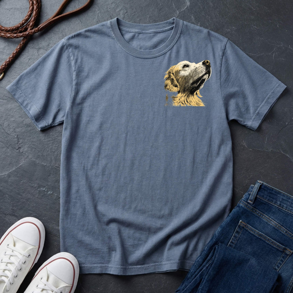 Blue Comfort Colors t-shirt with a dog graphic on a dark surface with shoes and jeans.