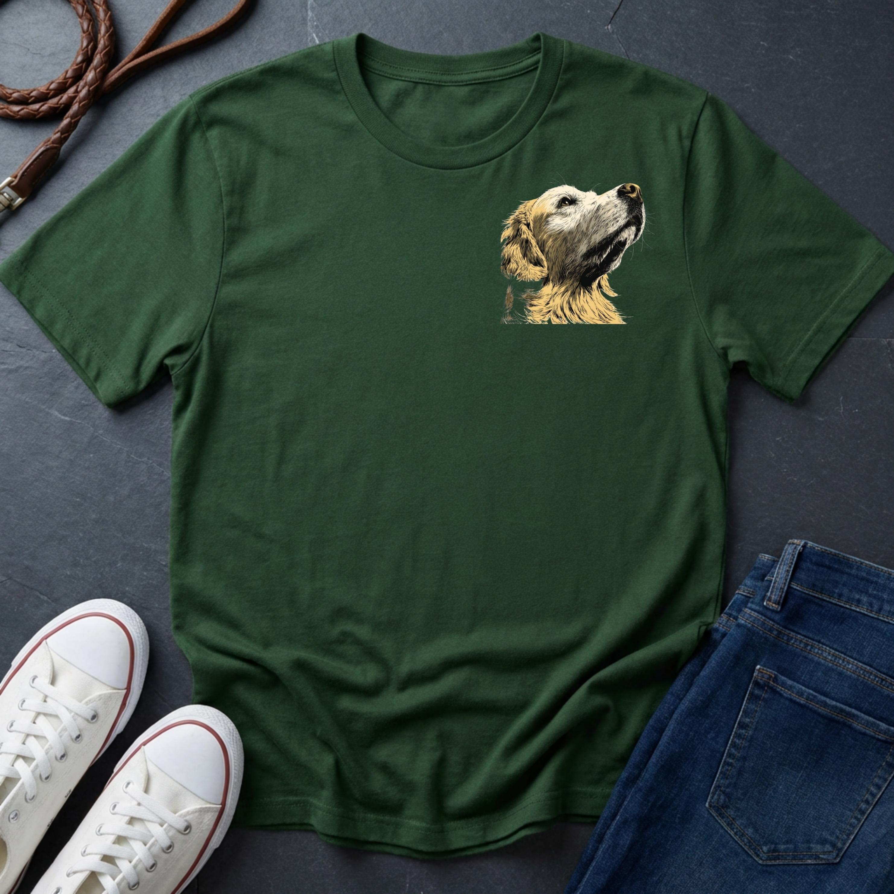 Green Comfort Colors t-shirt with a dog graphic on a dark surface with shoes and jeans.