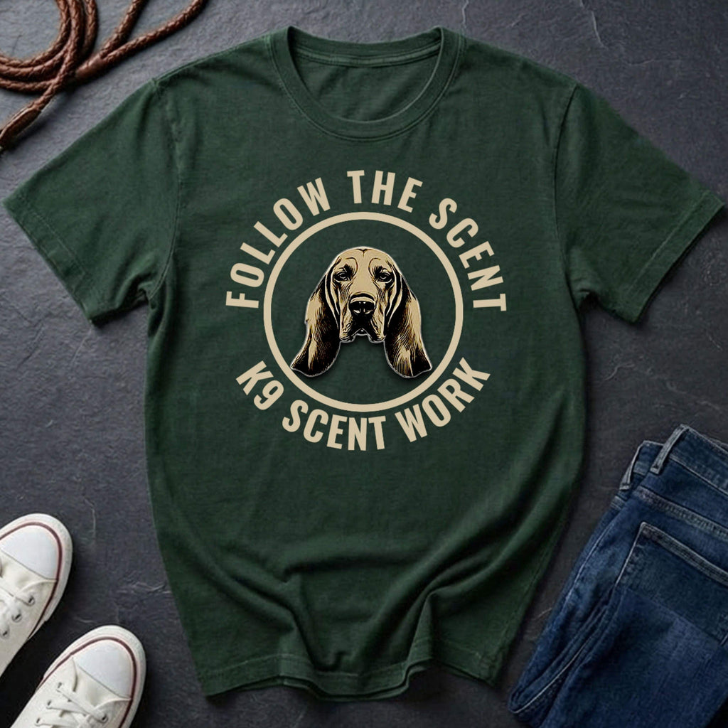 Green Comfort Colors t-shirt with a dog graphic and text 'Follow the Scent K9 Scent Work' on a dark surface.