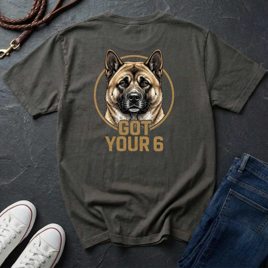 Green Comfort Colors t-shirt with a dog graphic and 'Got Your 6' text on a dark surface with shoes and jeans.