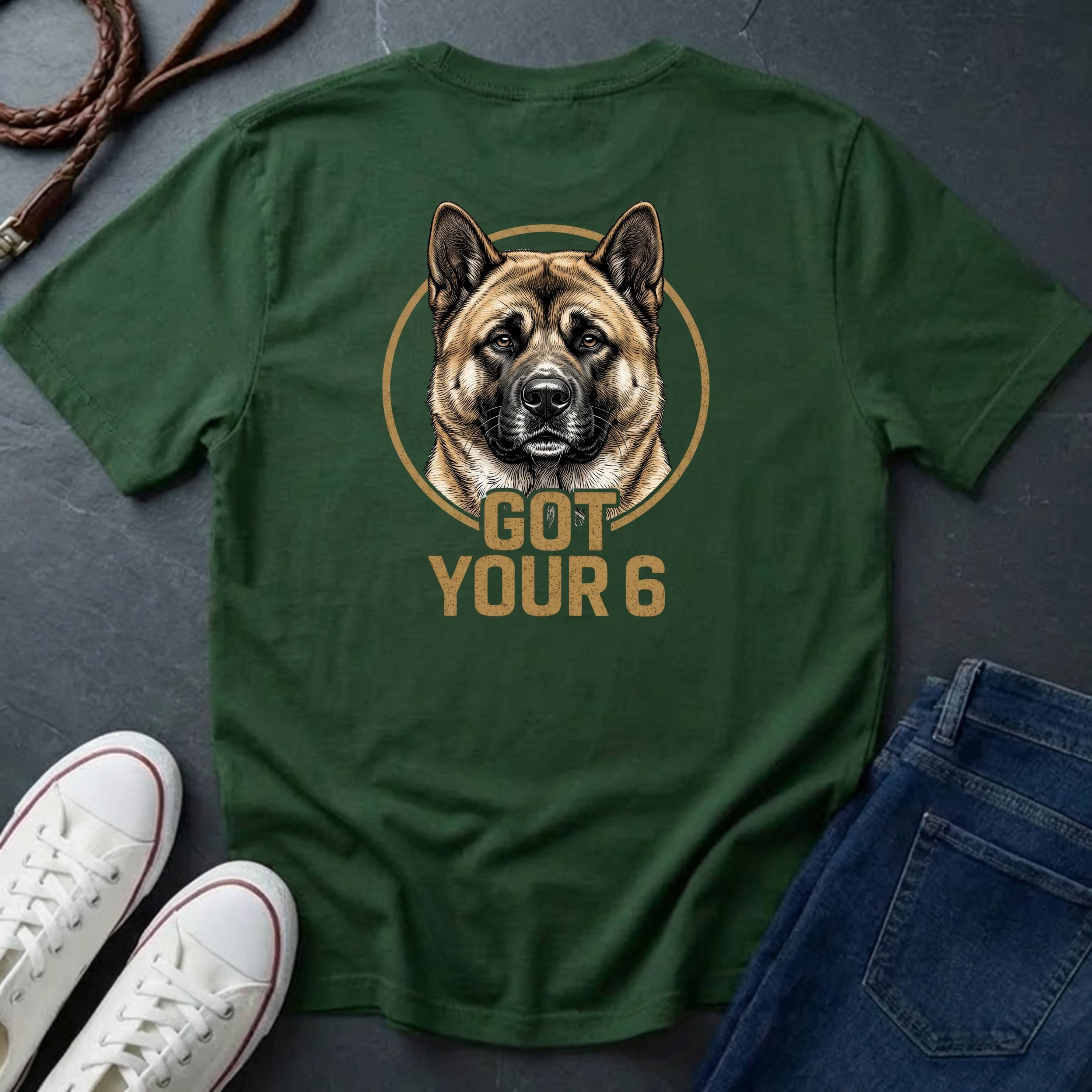 Green Comfort Colors t-shirt with a dog graphic and 'Got Your 6' text on a gray surface with shoes and jeans.