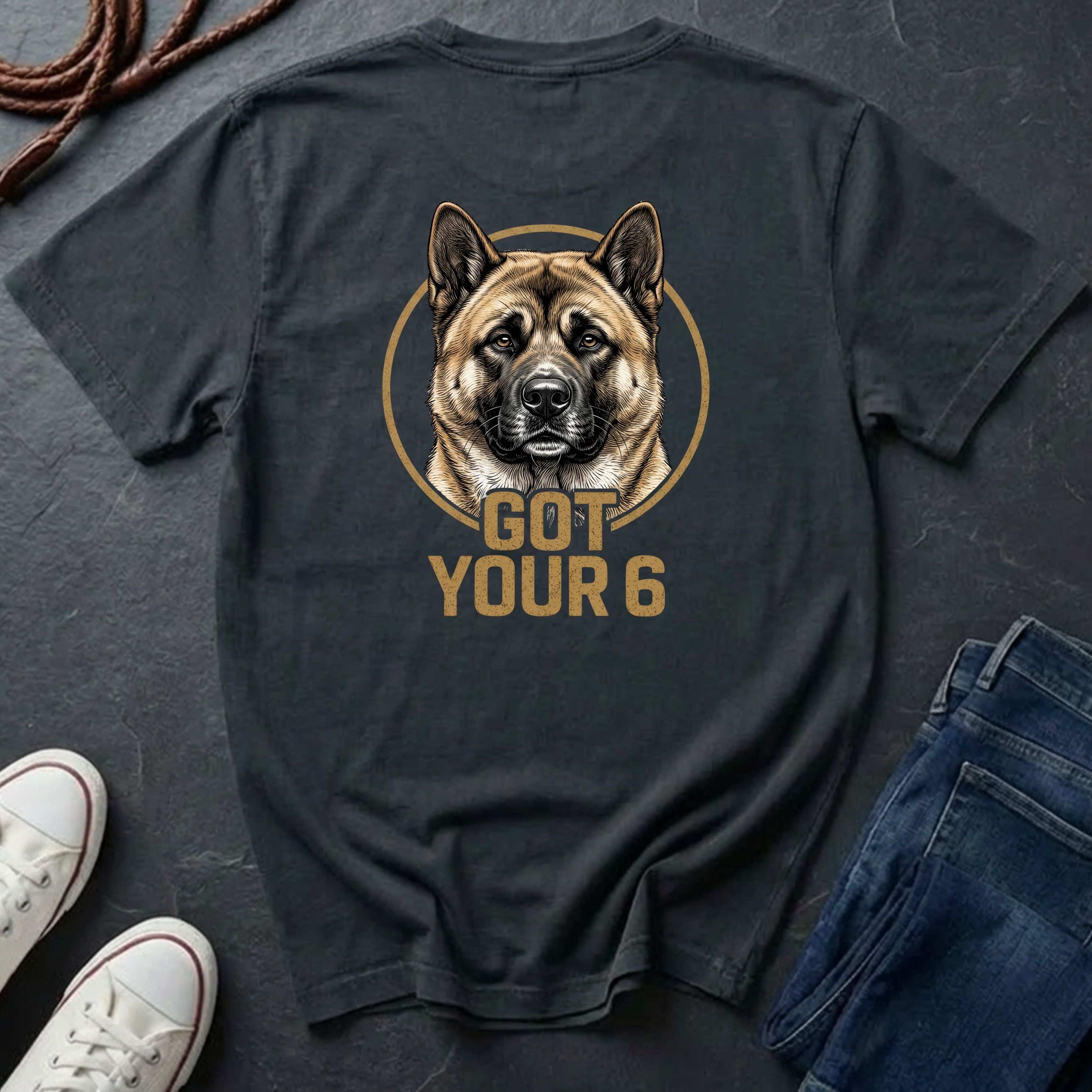 Black Comfort Colors t-shirt with a dog graphic and 'Got Your 6' text on a dark surface with shoes and jeans.