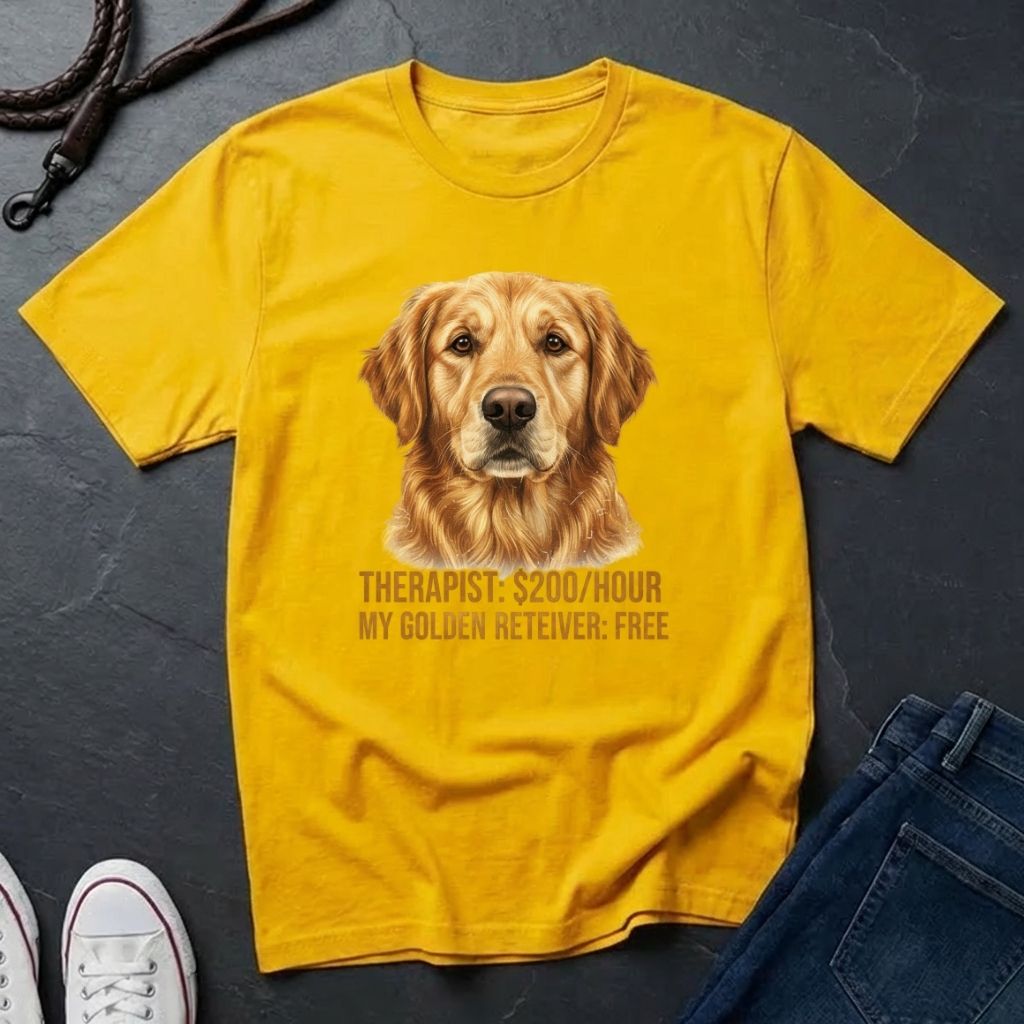Yellow Comfort Colors t-shirt with a golden retriever graphic and text on a dark surface.