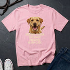 Pink Comfort Colors t-shirt with a dog graphic and text on a dark surface