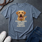 Blue Comfort Colors t-shirt with a dog graphic and text on a dark surface with shoes and jeans.